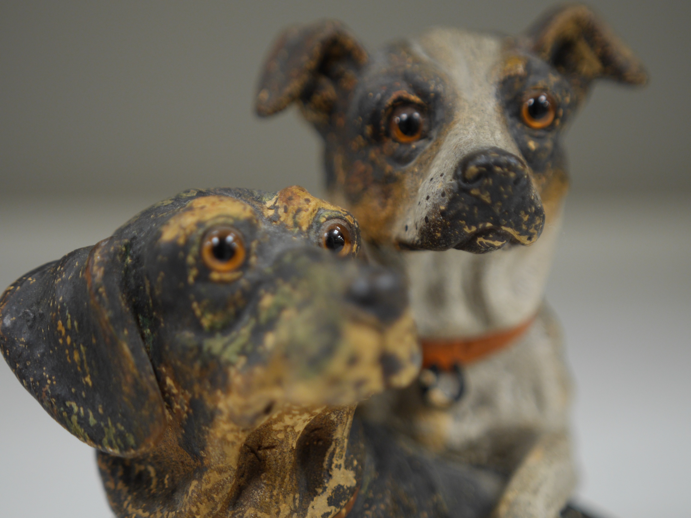 An Austrian cold painted terracotta model of a terrier and dachshund, 19cm high. Condition - one paw broken and reglued some paint worn